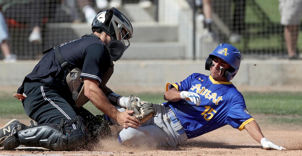 Catcher Antonio Ventimiglia of Huntington Beach tags out Bishop Amat baserunner Brenden Rodriguez at home plate Tuesday.