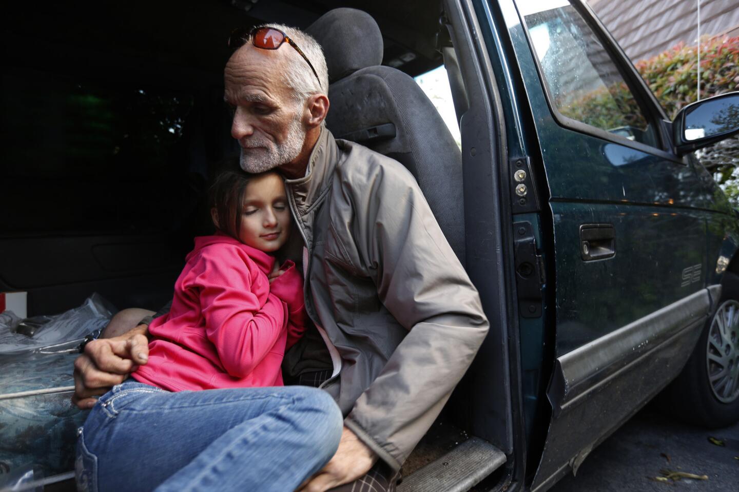 "It's been a tough year," said Thomas Goodwin, 54, with his daughter Leilani Miranda Duenez Goodwin, 7, in the van that has been their home for several months. They participate in the 'safe parking' program in Santa Barbara.