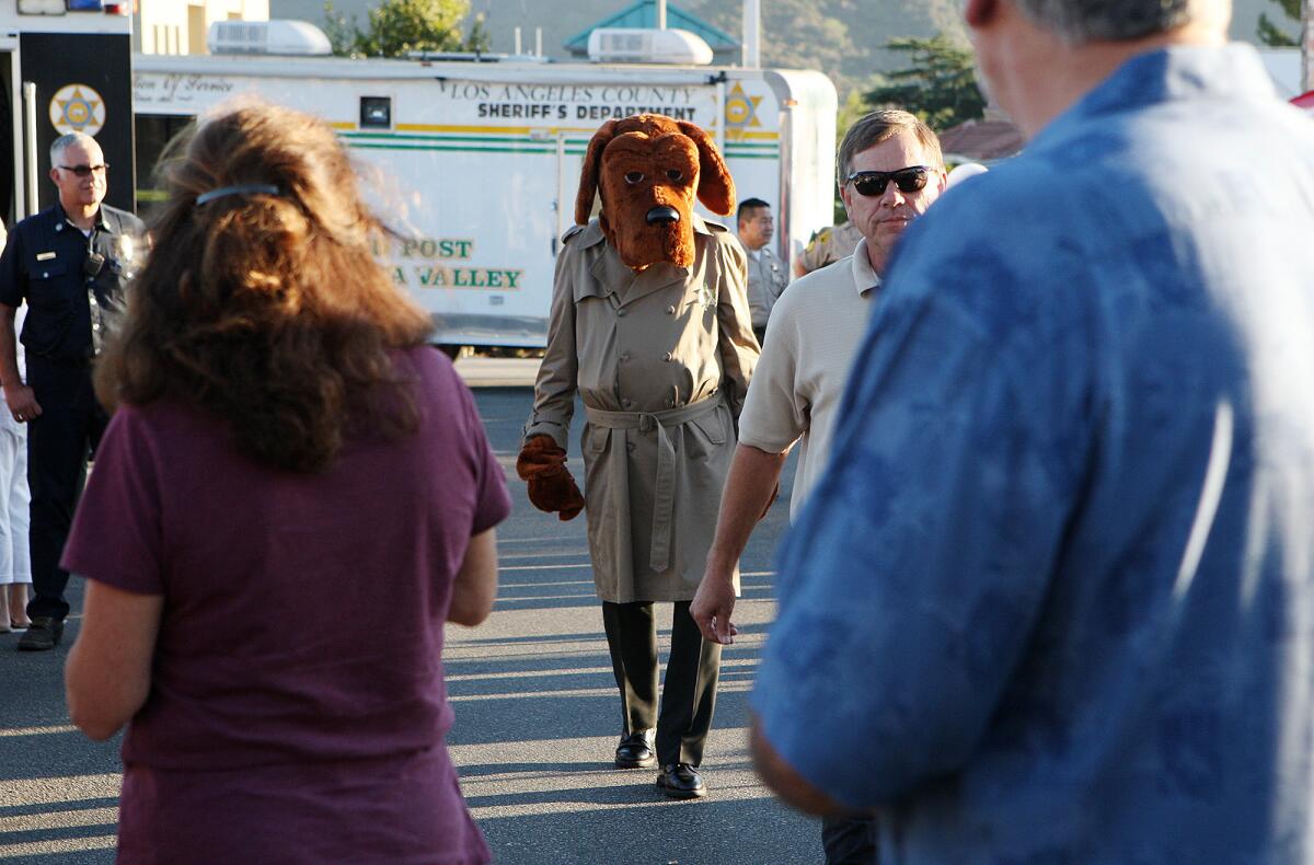 McGruff the Crime Dog strolls among the guests during the 30th National Night Out, where the communities of La Crescenta, Montrose and La Canada Flintridge participate in the event at the parking lots of Ralph's Fresh Air Market in La Crescenta on Tuesday, August 6, 2013.