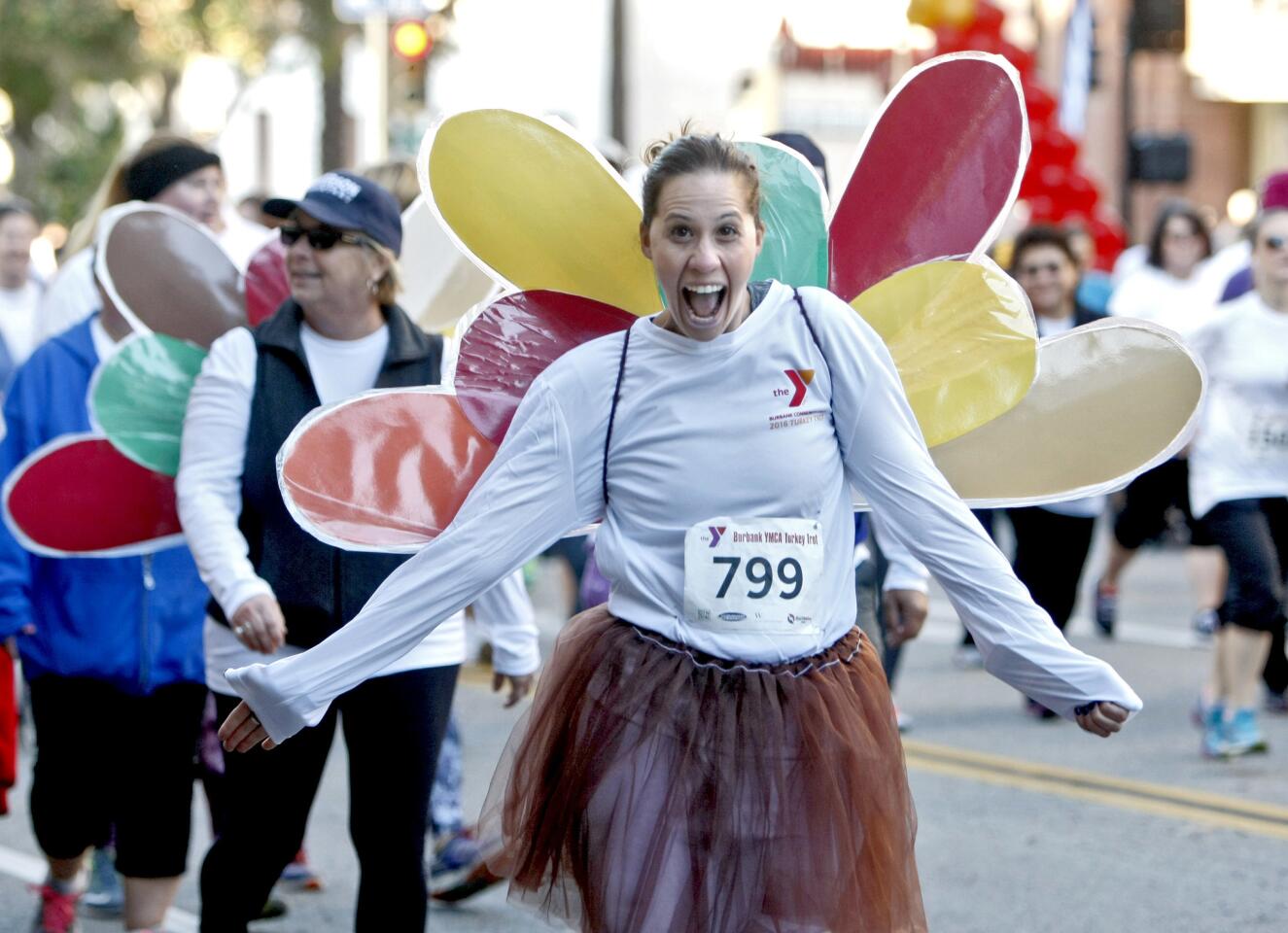 Wearing a turkey costume, Jill Pomfet of Sunland smiles as she starts the 2016 Burbank YMCA Turkey Trot on Thanksgiving Day in downtown Burbank on Thursday, Nov. 24, 2016. About 2,500 participants ran in the 10K, 5K and kids' run.