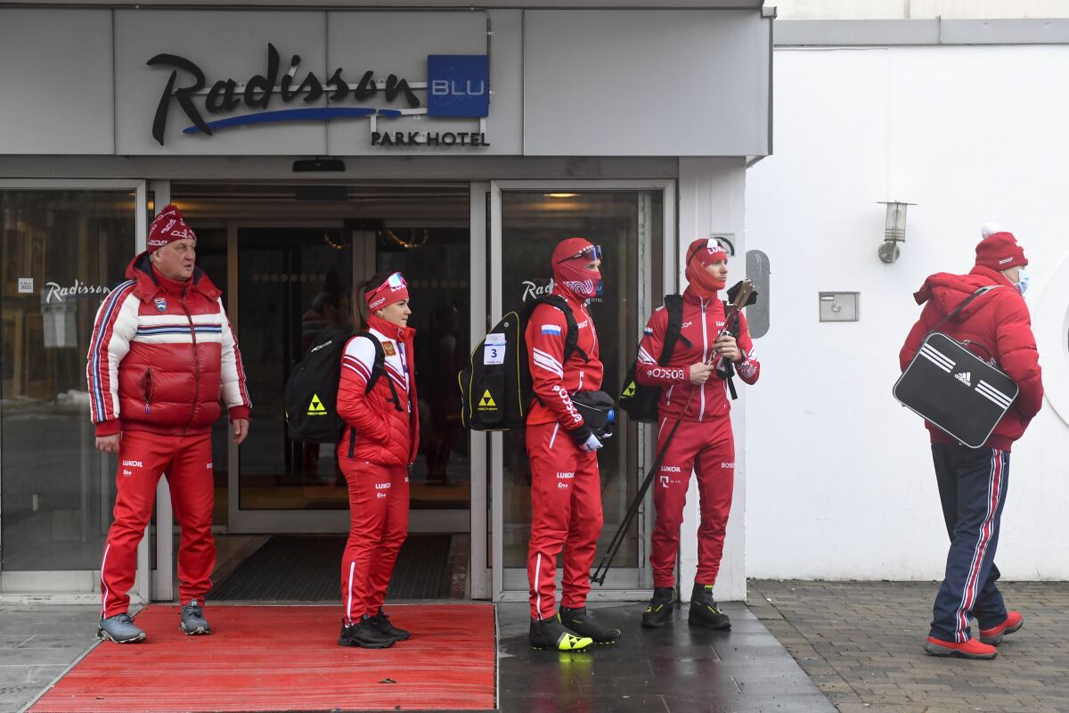 Members of the Russian cross-country ski national team stand outside the Radisson Blu Hotel at Fornebu, Oslo, Tuesday March 1, 2022. Norway challenged a decision by the International Ski Federation to allow Russians to keep competing, and said it would block them from upcoming rounds of the World Cup that Norway hosts this week. (Annika Byrde/NTB scanpix via AP)
