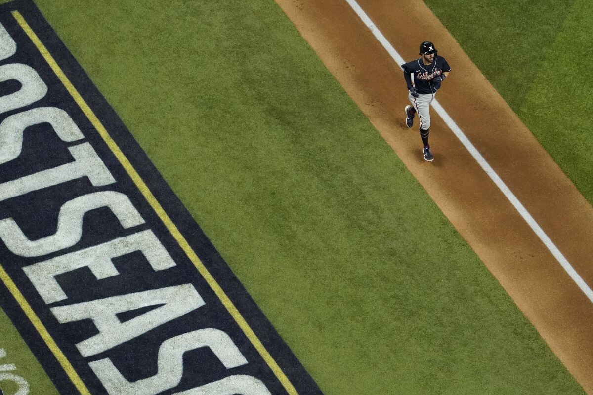 Atlanta's Dansby Swanson rounds the bases after hitting a home run off the Dodgers.