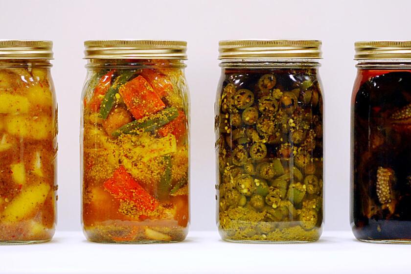 Pickles Indian -- L to R: Sour Lemon Pickle, Mixed Vegetable Pickle, Green Chile Pickle and Sweet and Sour Eggplant Pickle on 08/15/2002.