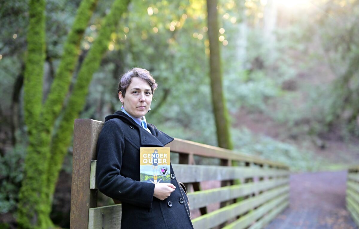 Maia Kobabe stands with "Gender Queer: A Memoir" at North Sonoma Regional Park in Santa Rosa.