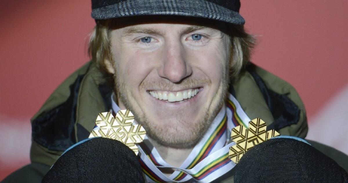 Ted Ligety holds up the two gold medals he has won at this year's world championships.