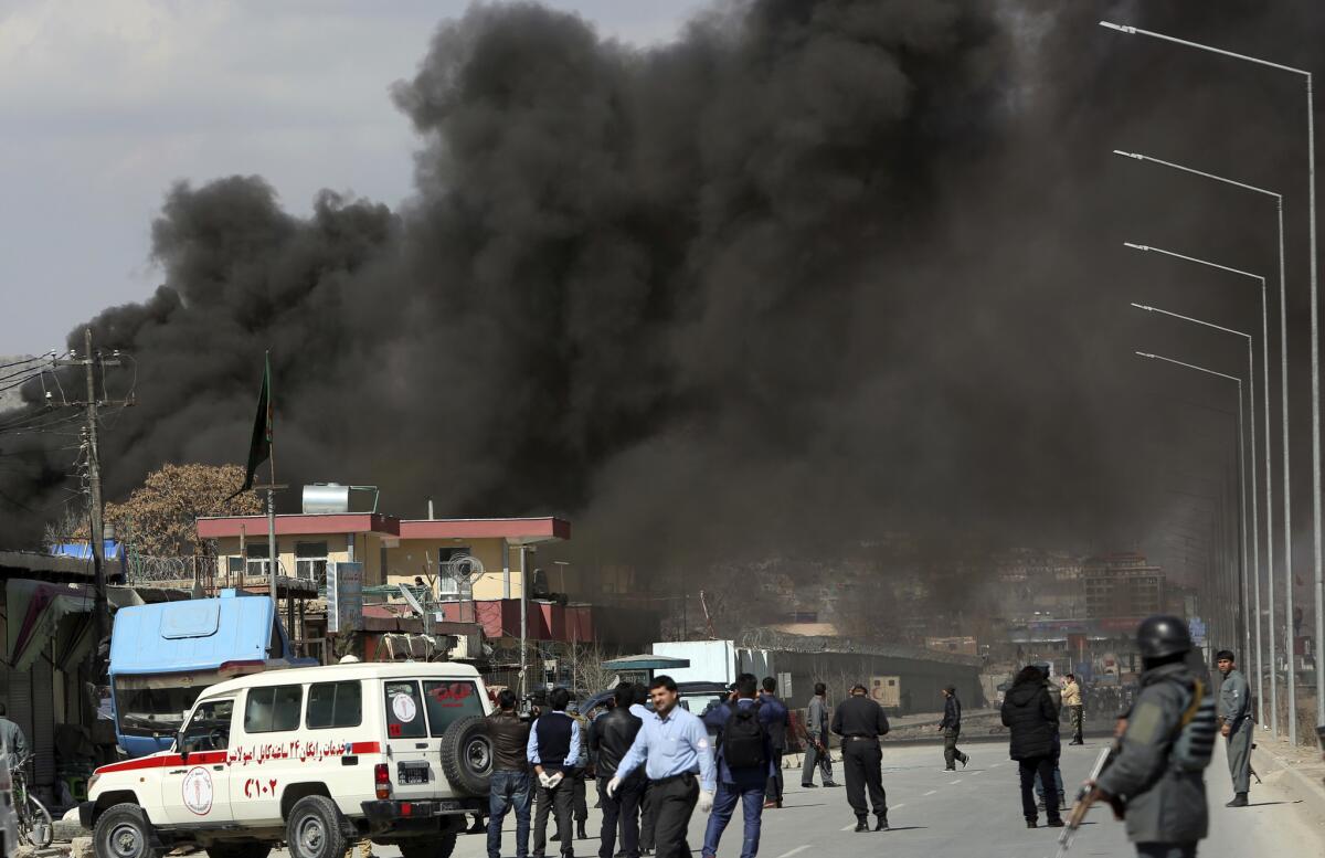 Smoke rises from a district police headquarters after a suicide bombing in Kabul, Afghanistan.