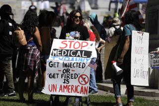 LOS ANGELES, CA - SEPTEMBER 18, 2021 - - Dozens of anti-vax protesters rally in front of City Hall in Los Angeles on September 18, 2021. An anti-vaxxer was stabbed and a reporter was sent to the hospital with a head injury at last month's rally at City Hall. (Genaro Molina / Los Angeles Times)