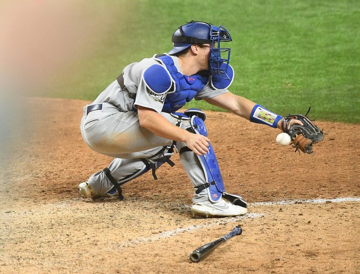 Dodgers catcher Will Smith drops the ball, allowing the Tampa Bay Rays to score the winning run.