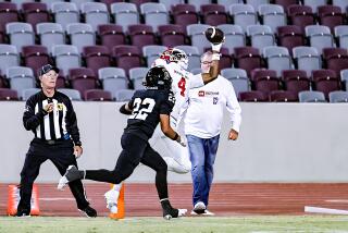 Kayden Dixon-Wyatt of Mater Dei makes a one-handed touchdown catch in the third quarter against Servite.