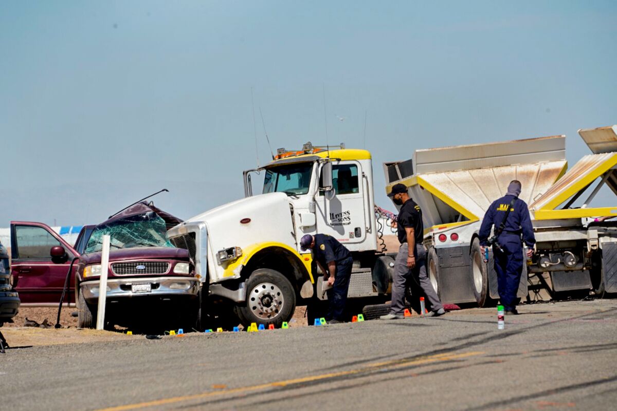 Law enforcement inspect the scene of a deadly crash at State Route 115
