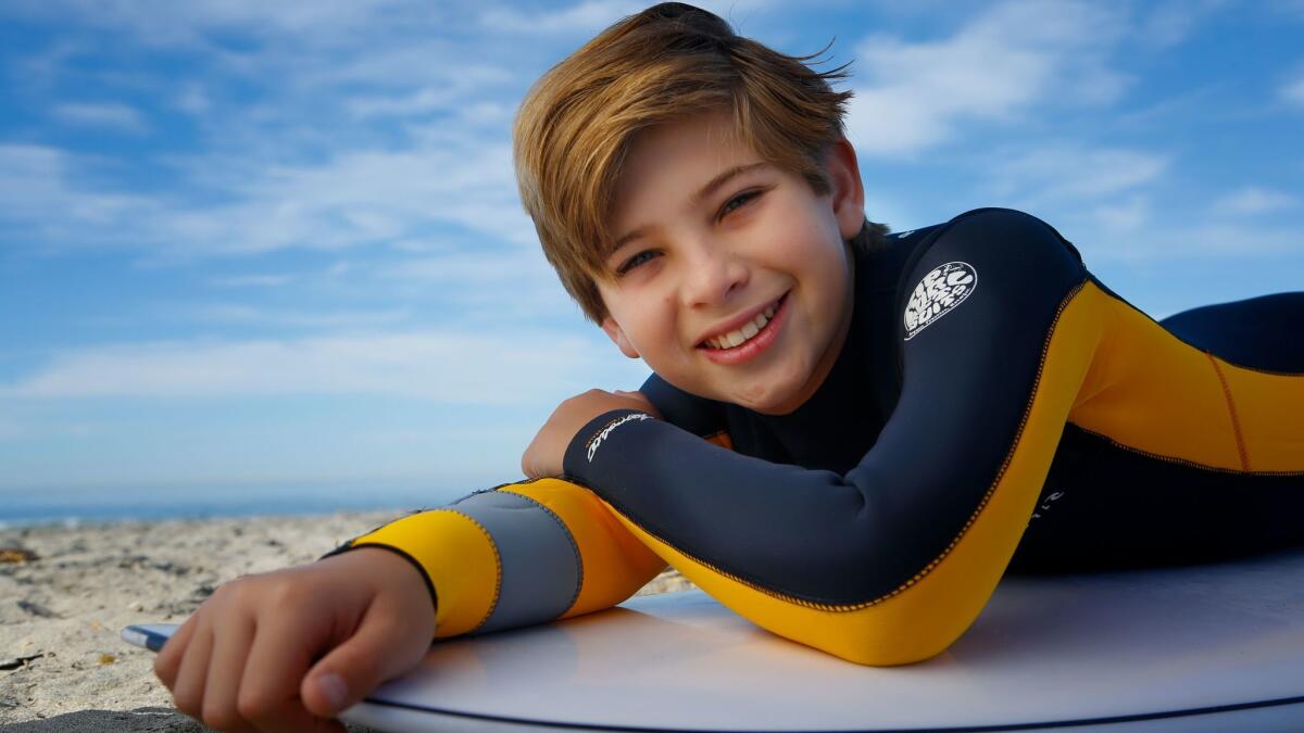 Noah Baird, 12, of Carlsbad is enjoying his first surfing season at Cardiff State Beach. The young musical theater actor will be featured on "A Christmas Story: Live" on Fox Television Dec. 17.