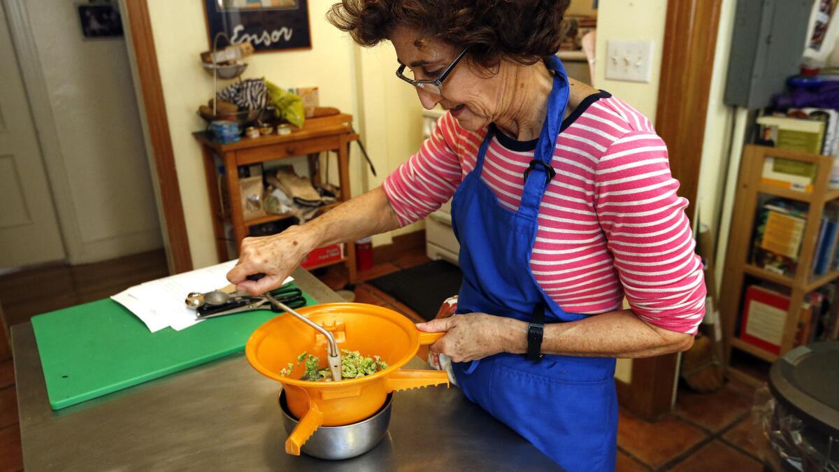 Martha Rose Shulman puts fava beans through her food mill to make a purée.