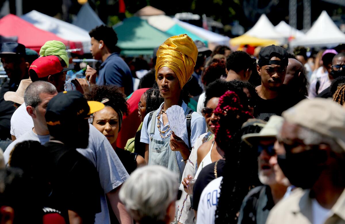 Crowds of people converge on Degnan Boulevard for a Juneteenth festival in Leimert Park on Saturday.