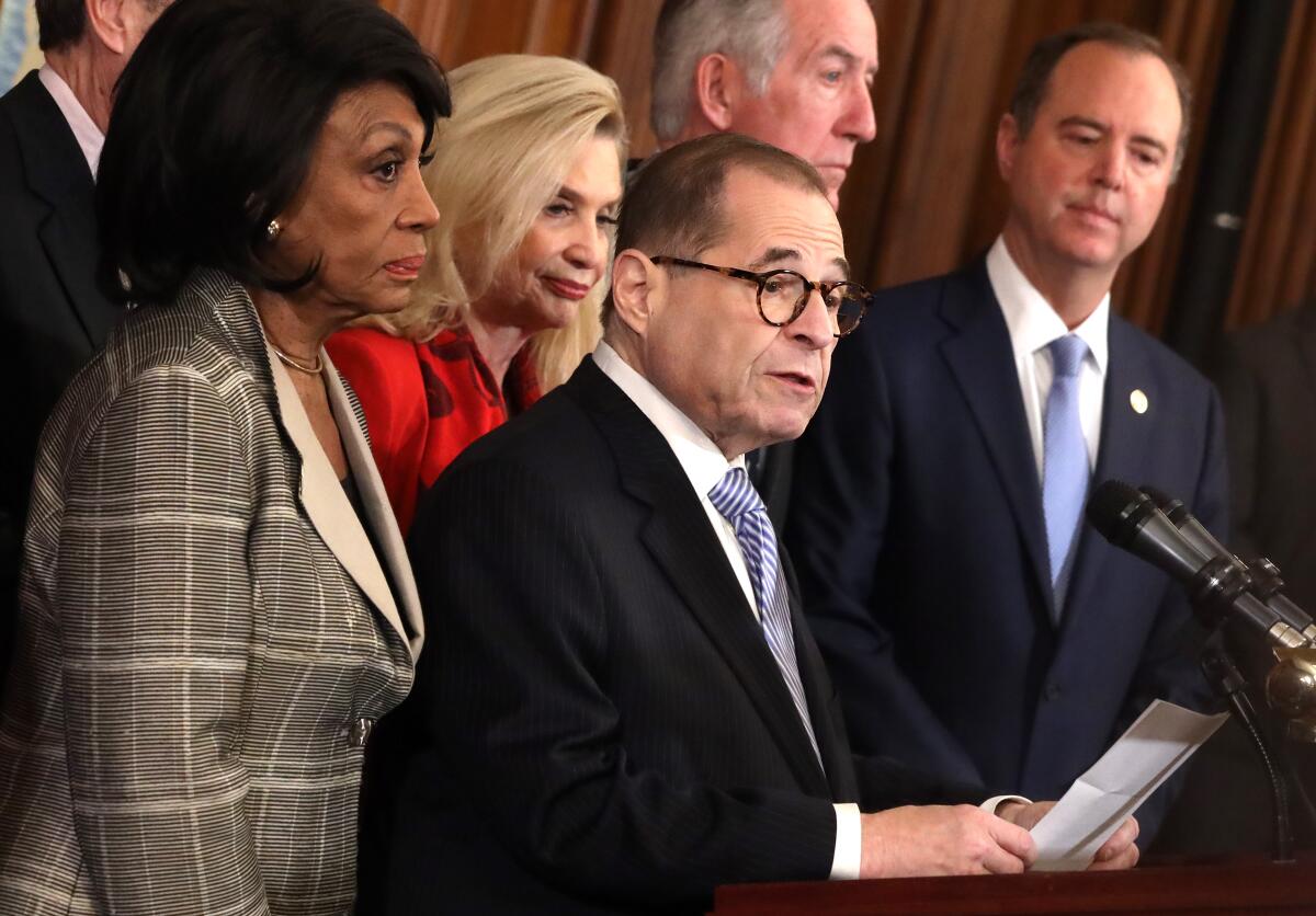 House Judiciary Committee Chairman Jerrold Nadler (D-N.Y.) speaks as other House committee leaders listen during a news conference at the Capitol on Tuesday to announce two articles of impeachment to be brought against President Trump.