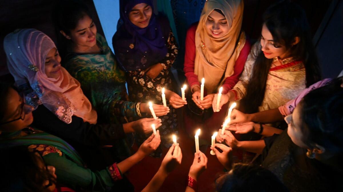 Women in Dhaka, Bangladesh, attend a candlelight vigil to mark International Women's Day on Thursday evening.