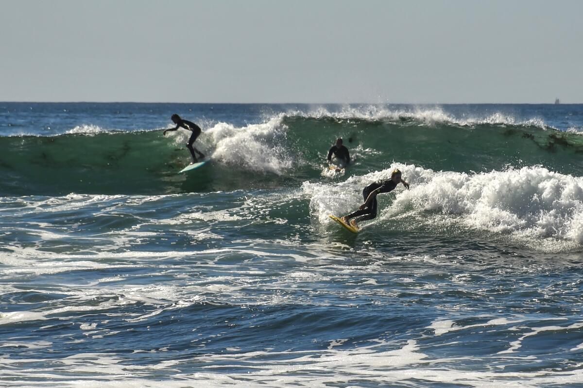 Surfers, body-surfers and surfers' shack at Windansea Beach, La Jolla.