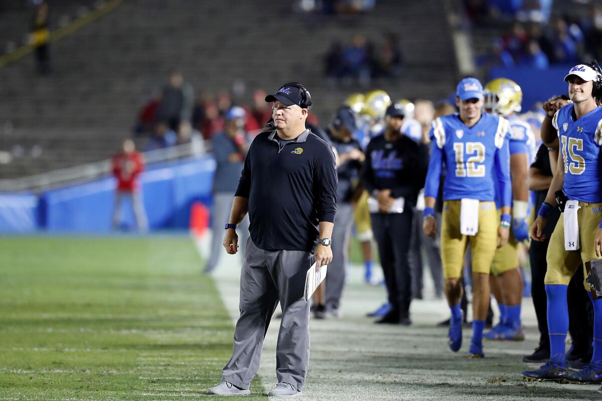 UCLA coach Chip Kelly watches the Bruins lose to Utah in a largely empty Rose Bowl last season.