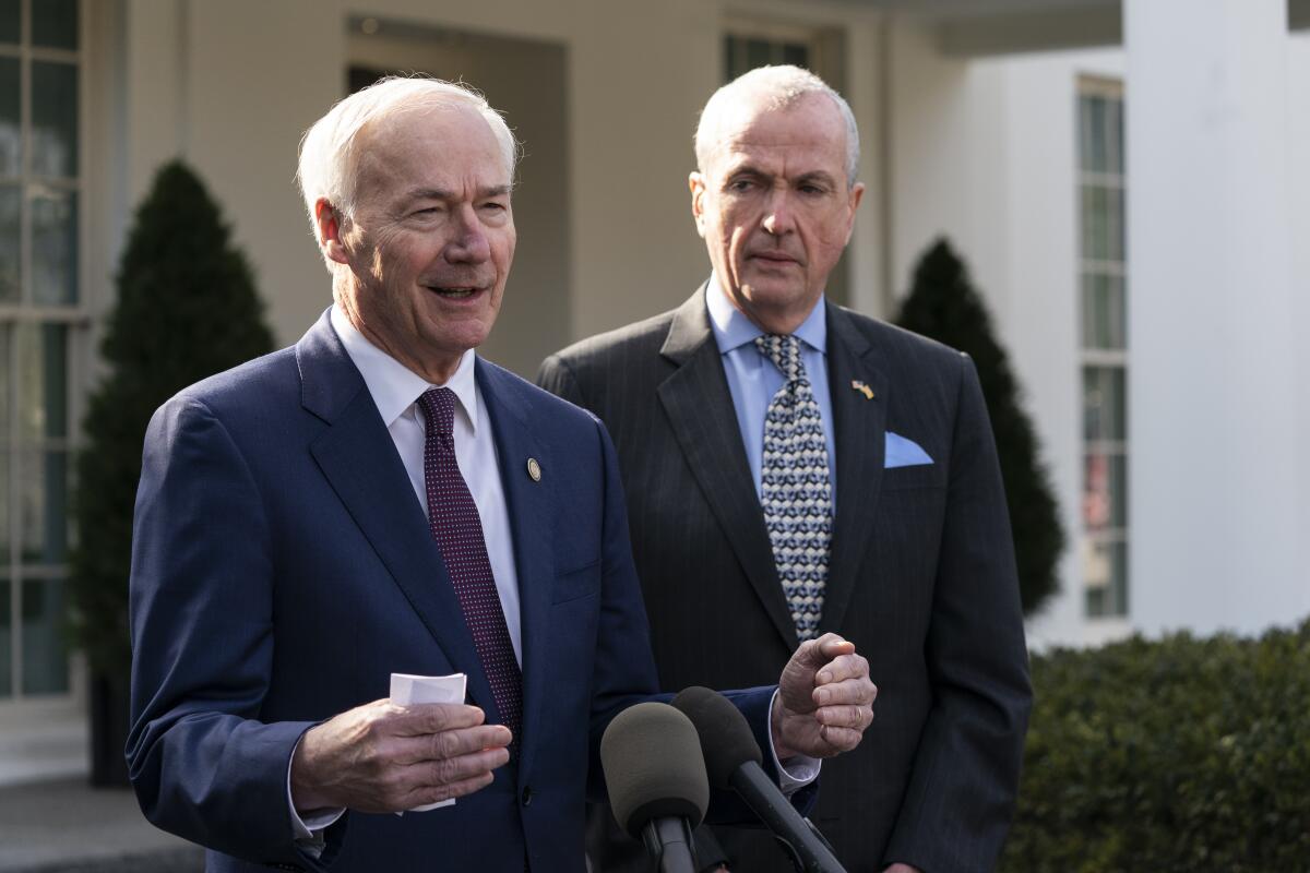 FILE - Arkansas Gov. Asa Hutchinson, R-Ark., left, and New Jersey Gov. Phil Murphy, D-N.J., speak with reporters outside during a meeting with the National Governors Association in the East Room of the White House on Jan. 31, 2022, in Washington. The National Governors Association is holding its summer meeting in person for the first time since 2019, after meeting virtually because of the COVID-19 pandemic. The three-day meeting, starting Wednesday, July 13, 2022, in Portland, Maine, follows recent high court rulings overturning Roe v. Wade and striking down gun restrictions by New York. (AP Photo/Alex Brandon, File)