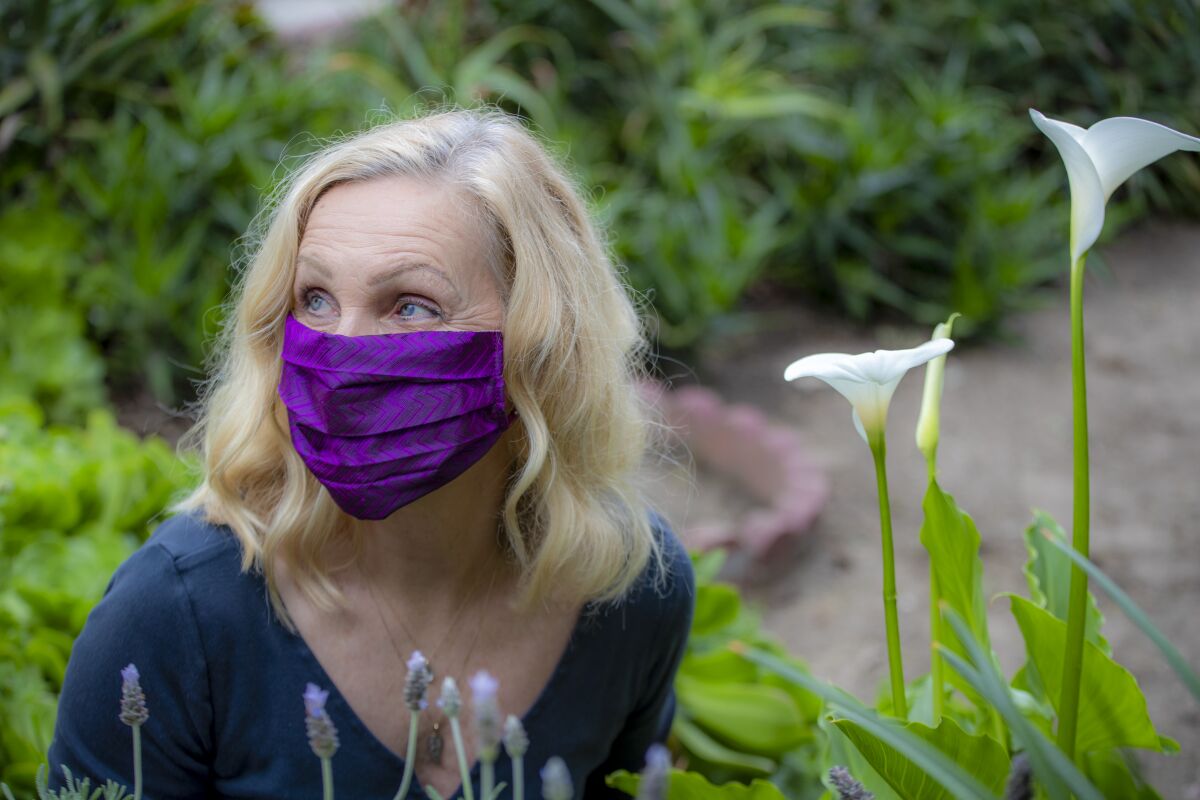 Fashion designer Deborah Lindquist models one of her eco facial masks.