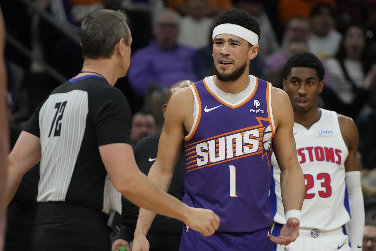 Phoenix Suns guard Devin Booker (1) reacts after getting ejected from the game by referee J.T. Orr (72) during the first half of an NBA basketball game against the Detroit Pistons, Wednesday, Feb. 14, 2024, in Phoenix. (AP Photo/Rick Scuteri)