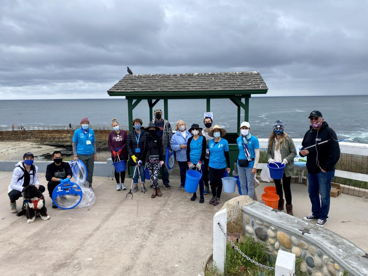 Volunteers gather above the Children's Pool beach April 22 to rid the area of litter.
