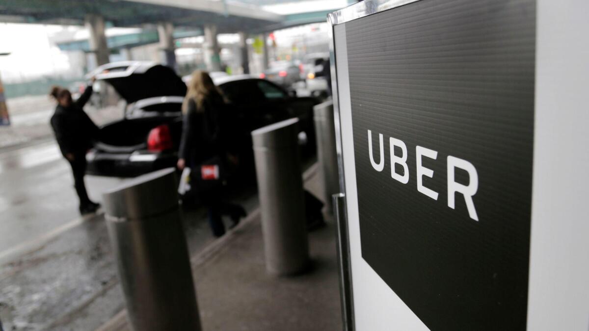 A sign marks a pickup point for Uber at LaGuardia Airport in New York.