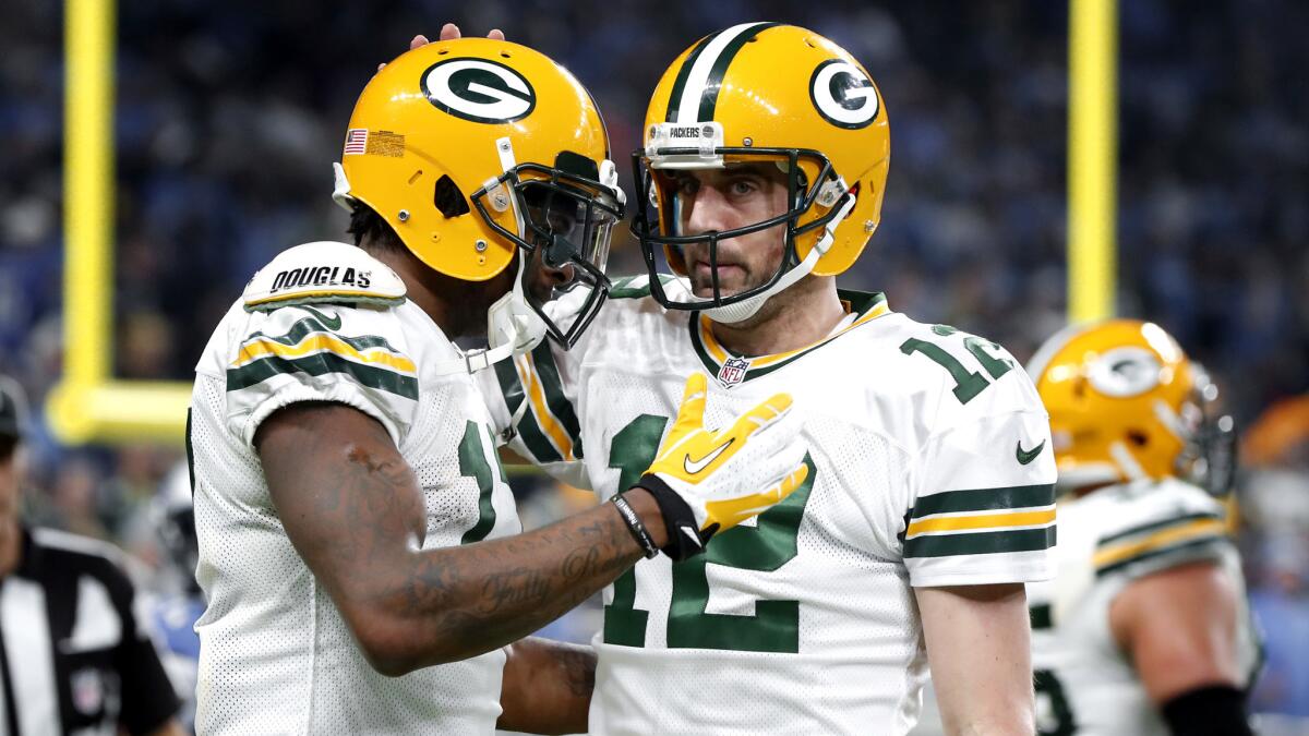 Packers receiver Davante Adams, left, and Aaron Rodgers celebrate a touchdown during a win in Detroit. Green Bay will not get to host a wild-card playoff game.
