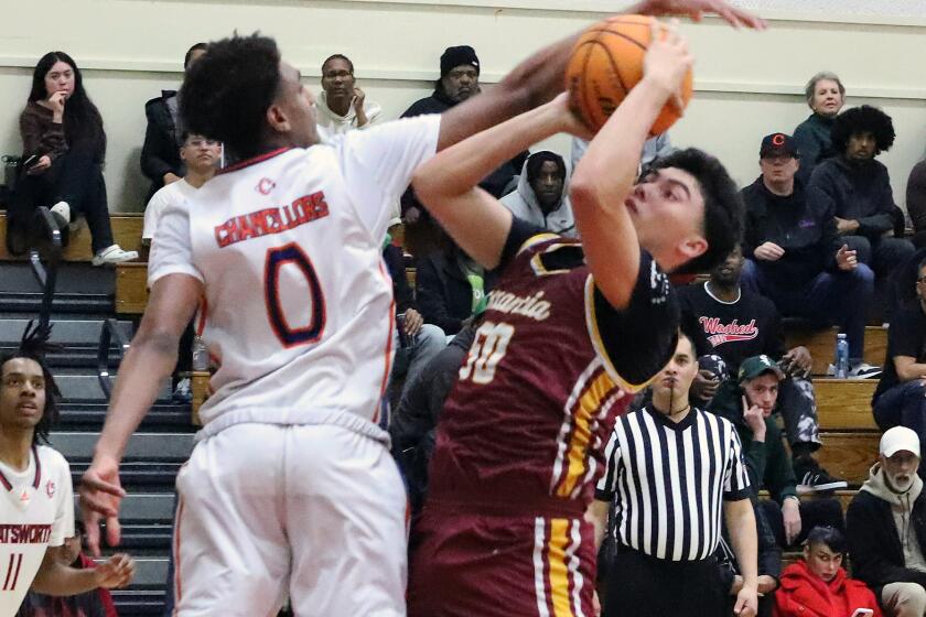 Estancia's Ryan Carrasco drives to the basket against Chatsworth's Alijah Arenas