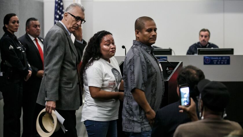 A tearful Teresa Dominguez, mother of Jesse Romero, center, speaks at the Los Angeles Police Commission meeting.