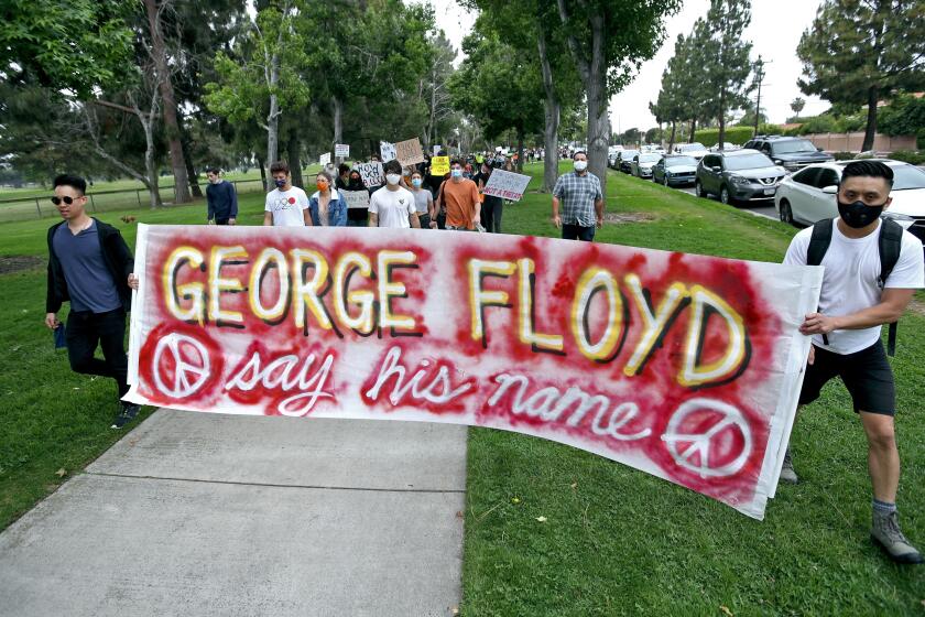 Hundreds marched around Mile Square Regional Park in support of Black Lives Matter/George Floyd, in Fountain Valley on Thursday, June 4, 2020.