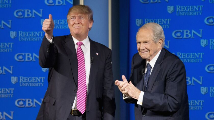 A Vatican-approved journal criticized leading U.S. televangelists, such as Pat Robertson, here with then-presidential candidate Donald Trump in 2016, for spreading what it called a "pseudo-Gospel."