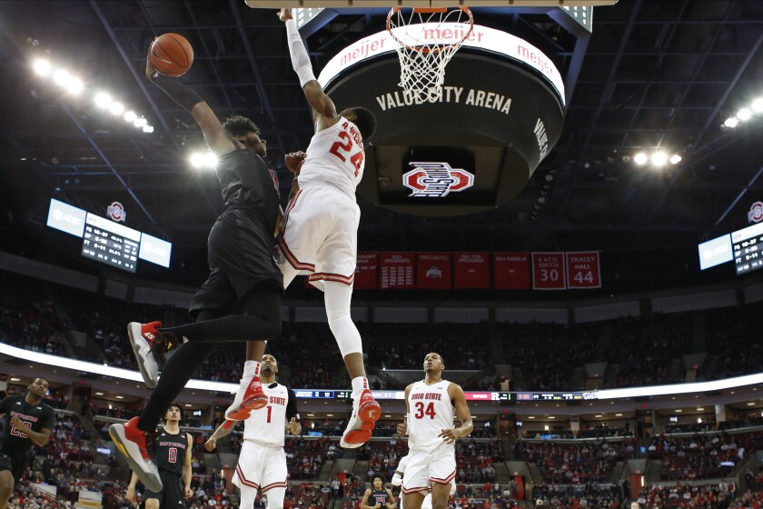 Rutgers' Myles Johnson, left, tries to dunk the ball over Ohio State's Andre Wesson during the second half of an NCAA college basketball game Wednesday, Feb. 12, 2020, in Columbus, Ohio. Ohio State beat Rutgers 72-66. (AP Photo/Jay LaPrete)