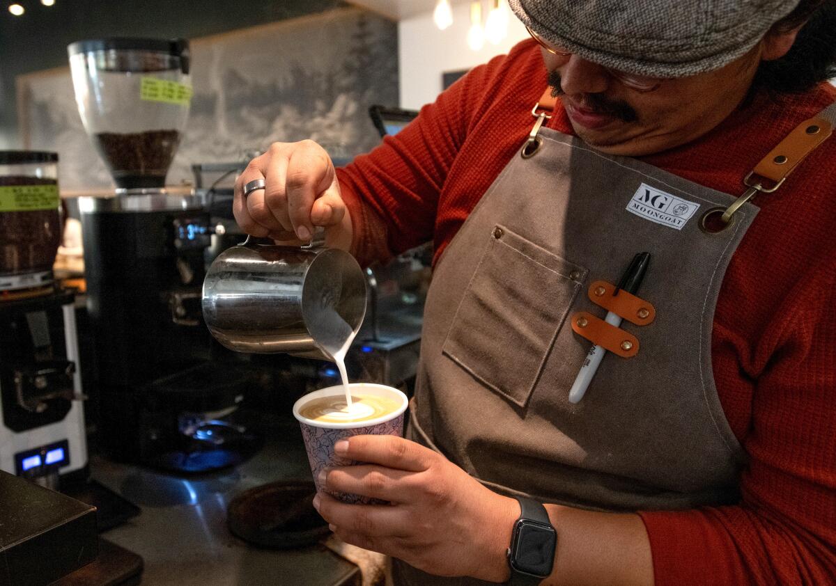Arturo Mandujano Jr. pours a latte at MoonGoat.