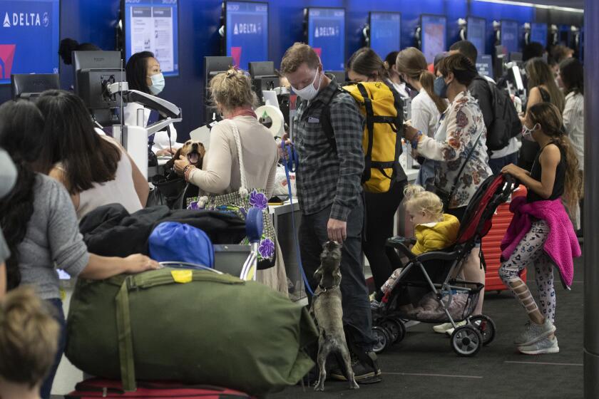 Los Angeles, CA - May 28: Amid a busy getaway travel day for the Memorial Day weekend and the first holiday since coronavirus pandemic restrictions have been relaxed, a crowd of travelers check in for their flights at LAX at Delta Airlines, Terminal 2 at LAX Friday, May 28, 2021. Officials say travelers should arrive early for Memorial Day weekend flights. After months of Los Angeles International Airport looking like a ghost town, holiday crowds are back. "We're seeing more travelers than we've seen in the last 14 months. We had over 75,000 people come through on Sunday alone to the TSA checkpoints, that's by far a record in 2021 for us," said LAX spokesperson Keith Montgomery. Photo taken in LAX on Friday, May 28, 2021 in Los Angeles, CA. (Allen J. Schaben / Los Angeles Times)