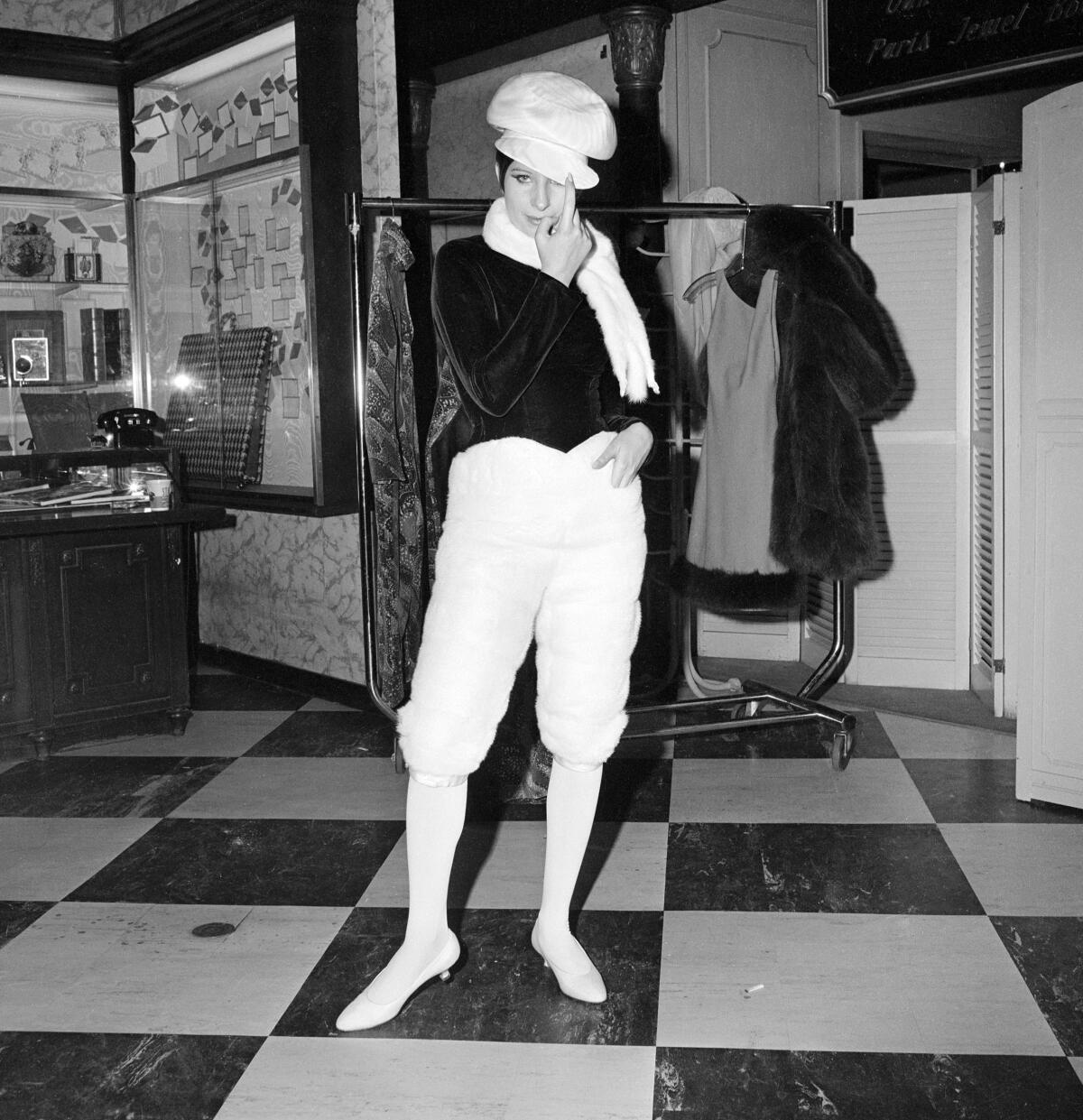 Barbra Streisand stands on a checkerboard floor in an empty department store in 1965.