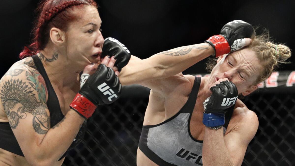 Holly Holm, right, and Cris Cyborg exchange blows during UFC 219 on Dec. 30 in Las Vegas.