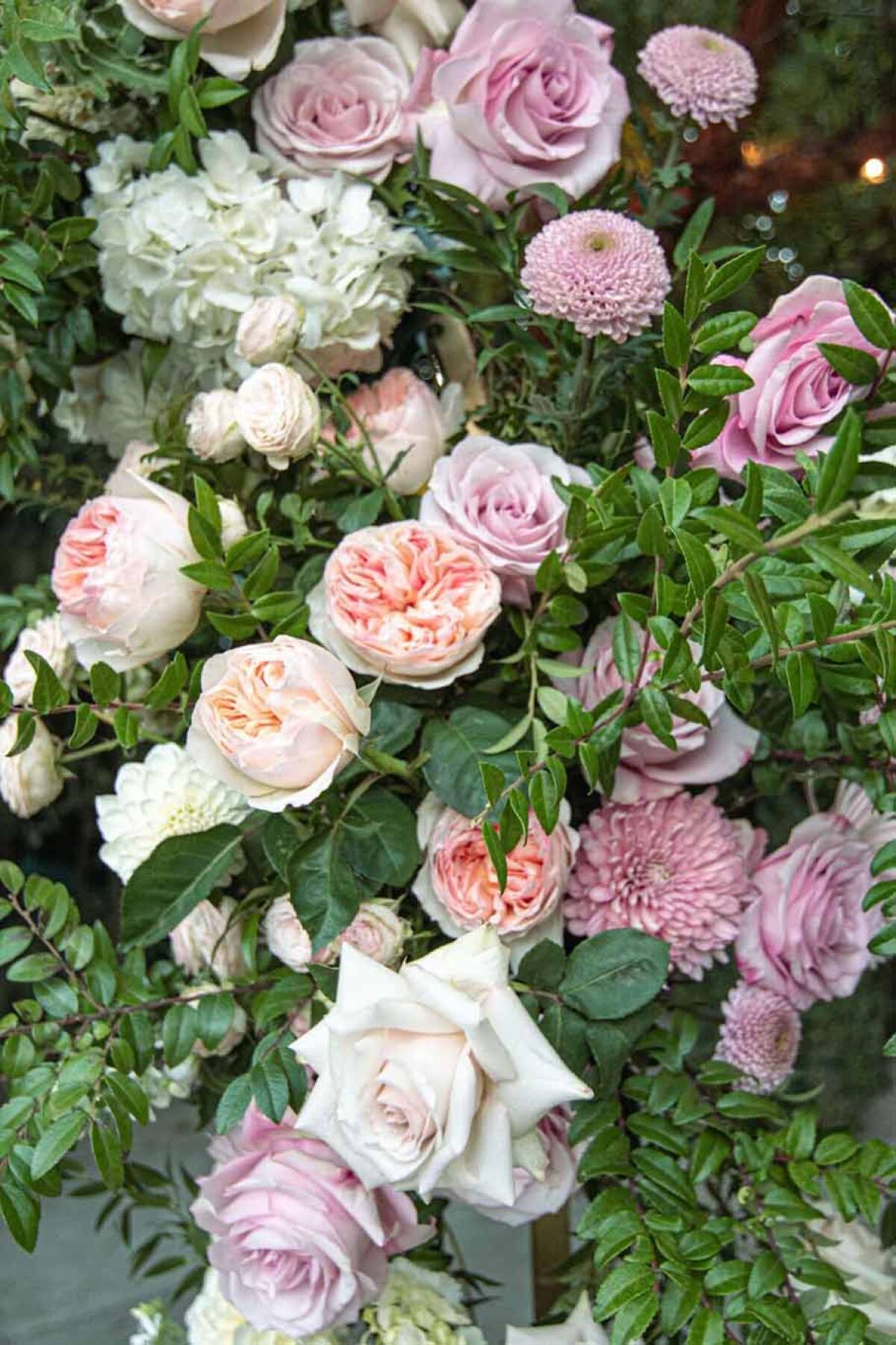 Hydrangeas, roses, chrysanthemums, and jasmine wreathe a whimsical floral arbor.