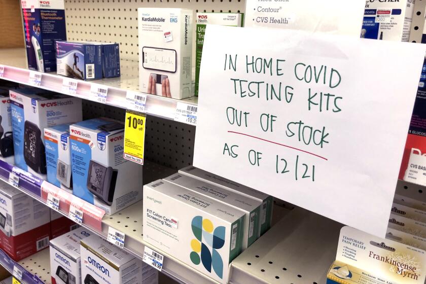TORRANCE CA DECEMBER 21, 2021 - A sign indicates no COVID in-home testing kets were available at this Torrance CVS on Tuesday, December 21, 2021.. A surge of coronavirus cases tied to the Omicron variant ahead of Christmas weekend has prompted a crush of demand for the over-the-counter antigen tests that can be conveniently taken at home. (Christina House / Los Angeles Times)