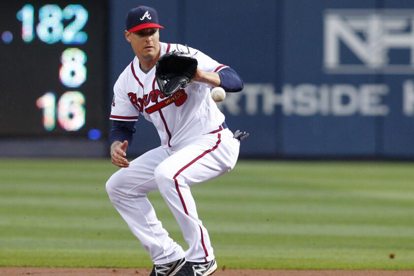 Former Atlanta Braves second baseman Kelly Johnson fields a ground ball in the first inning against the Philadelphia Phillies on May 12. The Mets reacquired Johnson on Wednesday.