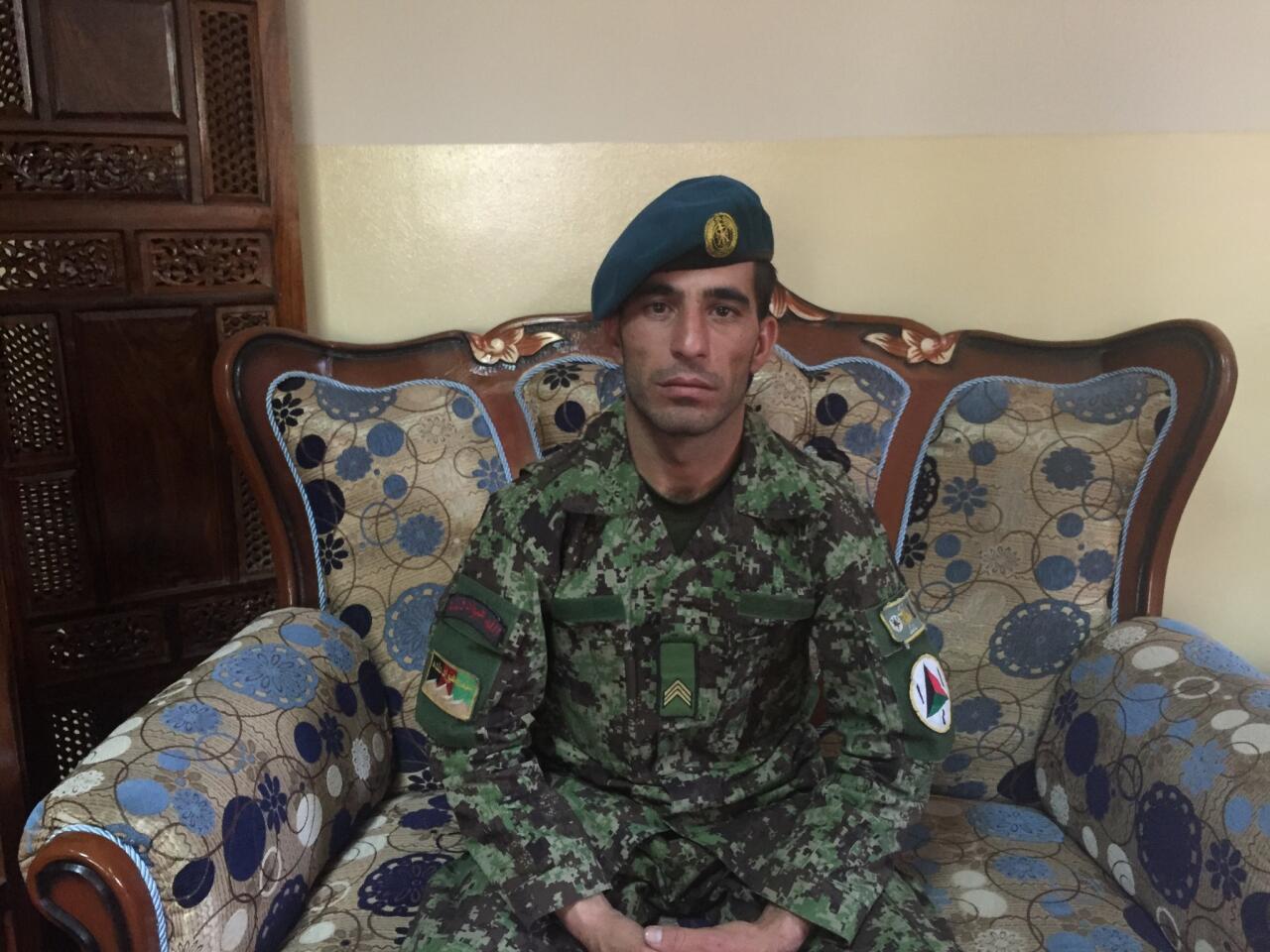 Afghan army Staff Sgt. Isa Khan Laghmani, 28, is shown Tuesday, one day after he says he shot all six Taliban gunmen threatening the parliament building in Kabul, Afghanistan.