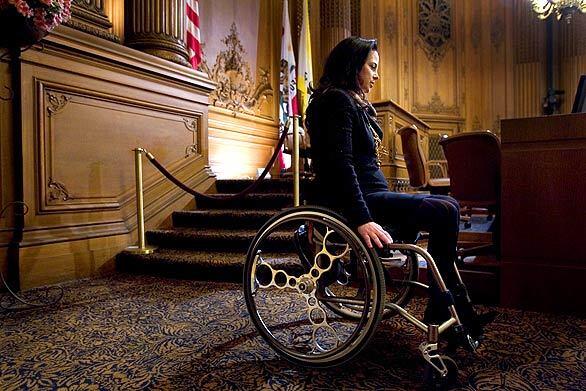"This is worth the battle because it's the law," says San Francisco County Supervisor Michela Alioto-Pier, who says the city is violating the Americans With Disabilities Act. Alioto-Pier, at the the bottom of the five stairs leading up to the board president's dais in the the supervisors' chamber, is suing the board over its refusal to build a ramp.