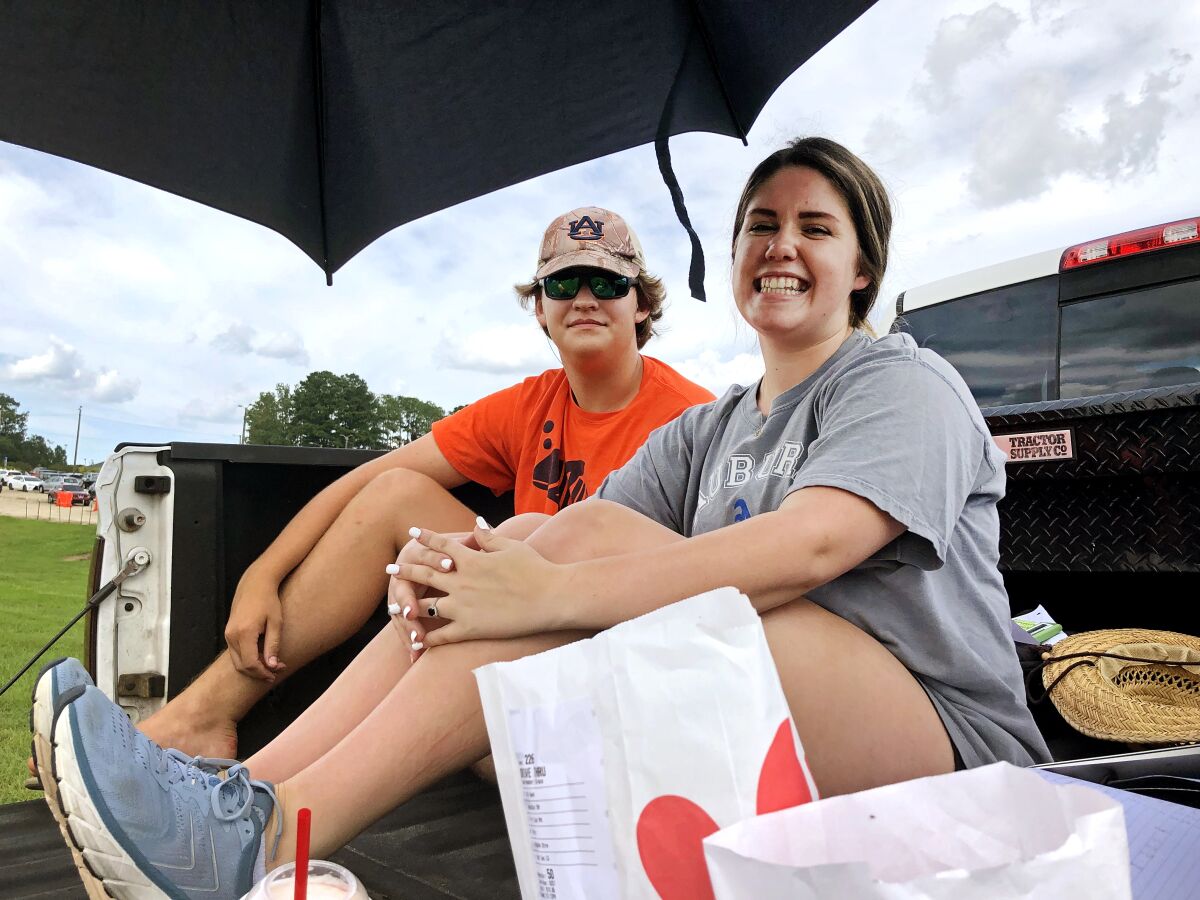 Lily Moreman, right, secures a prime tailgating spot Friday with her friend, Rylan Mayberry.