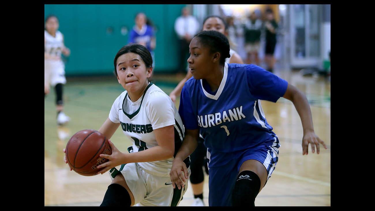 Providence High girls' basketball player Audrey Sayoc drives to the basket as Burbank's Jayla Flowers defends in semifinal play of the Providence Pioneers Shootout, at Providence High in Burbank on Tuesday, Nov. 20 2018.