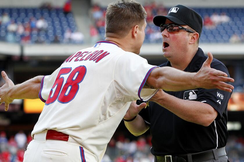 Phillies relief pitcher Jonathan Papelbon argues with umpire Marty Foster after getting ejected for making an obscene gesture after getting the final out against the Marlins in the ninth inning Sunday at Citizens Bank Park. Miami won the game, 5-4.