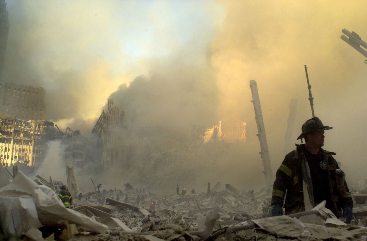 A firefighter moves through the debris at the World Trade Center on Sept. 11, 2001.