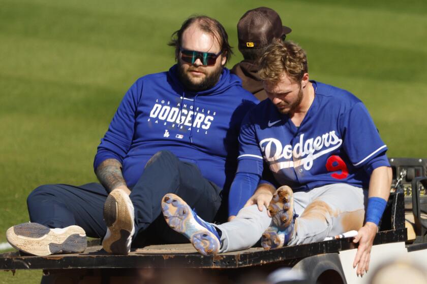 Peoria AZ - February 27: Los Angeles Dodgers' Gavin Lux is carted off the field after getting injured running to third base.