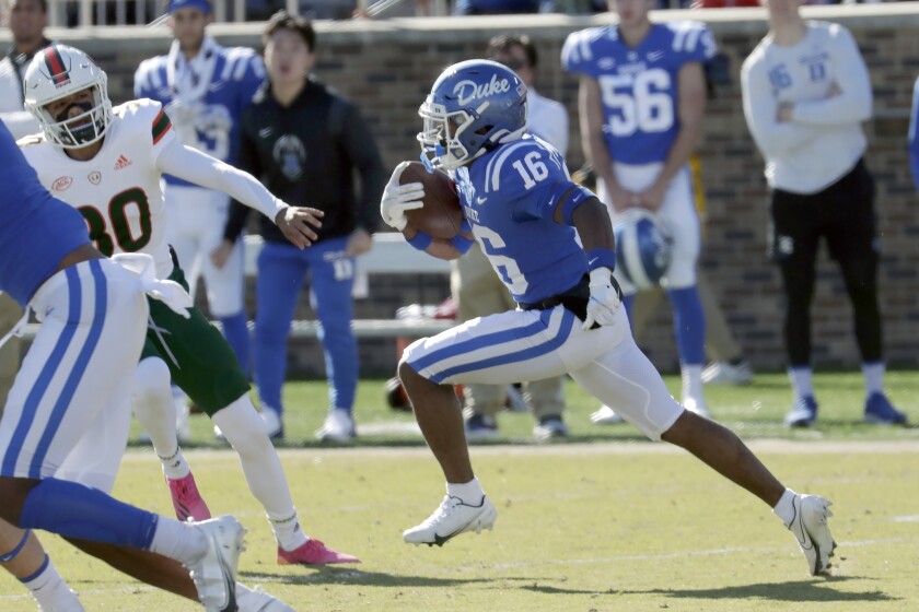 Duke safety Jaylen Stinson (16) goes past Miami place kicker Andres Borregales (30) as he runs a kickoff return back for a touchdown during the first half of an NCAA college football game Saturday, Nov. 27, 2021, in Durham, N.C. (AP Photo/Chris Seward)