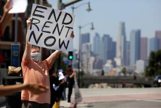 LOS ANGELES-CA-APRIL 1, 2020: Noah, who declined to give his last name, participates in a demonstration with members of the Los Angeles Tenants Union and their supporters at Mariachi Plaza in Boyle Heights on Wednesday, April 1, 2020 to demand rent forgiveness for the month of April due to the coronavirus pandemic's economic fallout. (Christina House / Los Angeles Times)