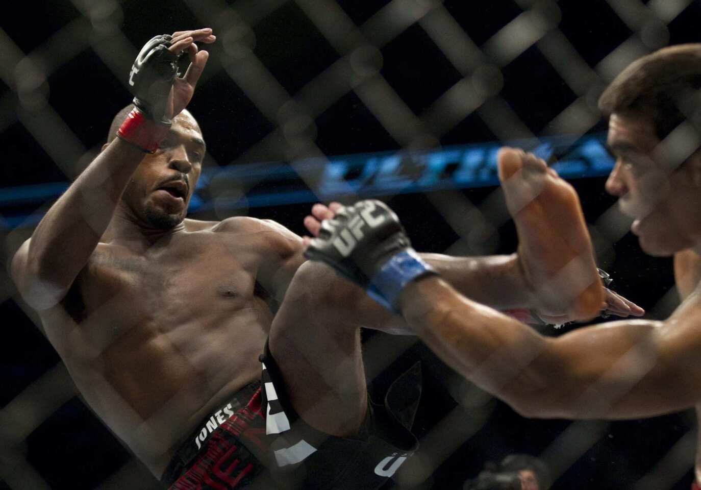 Jon Jones, left, lands a kick on Lyoto Machida during their UFC 140 Lightweight Championship fight on Dec. 10.