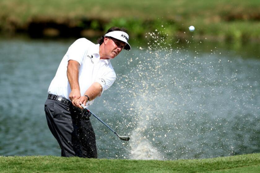 Phil Mickelson hits his second shot on the par-three 11th hole during the second round of the St. Jude Classic on Friday.